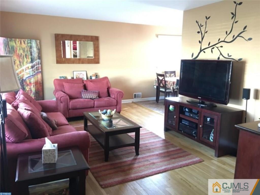 41 Miry Brook Road Hamilton, NJ 08690 - Photo 3 of 11 a living room with furniture and a flat screen tv