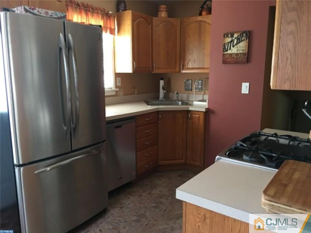 41 Miry Brook Road Hamilton, NJ 08690 - Photo 5 of 11 a kitchen with stainless steel appliances granite countertop a refrigerator and a sink