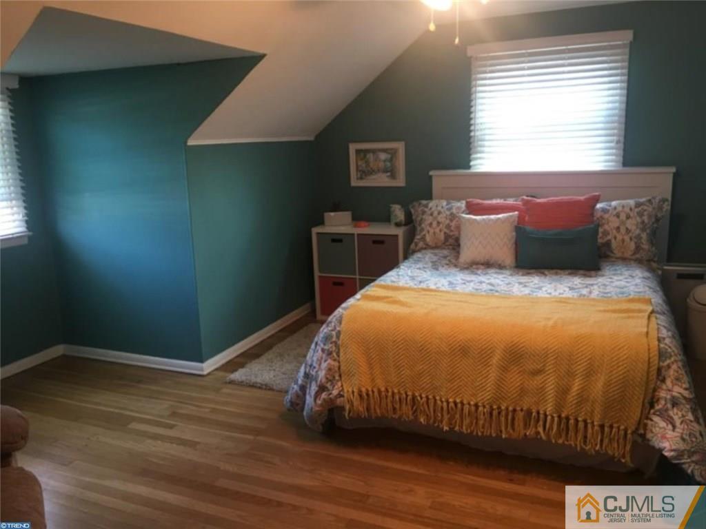 41 Miry Brook Road Hamilton, NJ 08690 - Photo 7 of 11 a bed sitting in a bedroom next to a window