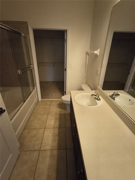 11446 Jasper Kay Terrace, Unit 1009 Windermere, FL 34786 - Photo 13 of 15 a bathroom with a sink a toilet and mirror