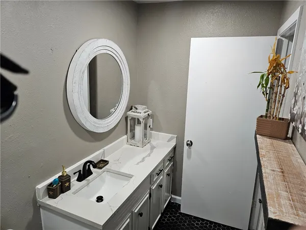 a bedroom with a bed and a flat tv screen next to a window