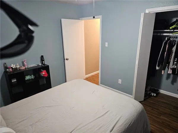a bedroom with a bed and a chandelier