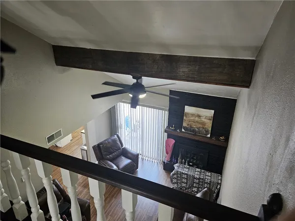 a view of a room with furniture and wooden floor