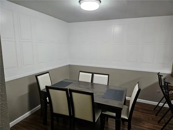 a kitchen with a refrigerator a stove and white cabinets