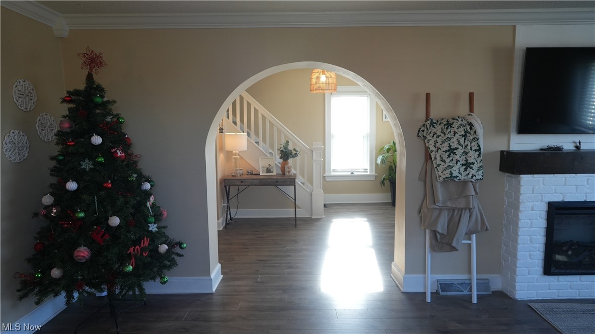 174 Powers Road Weirton, WV 26062 - Photo 12 of 33 Entryway featuring crown molding, a fireplace, and dark hardwood / wood-style floors