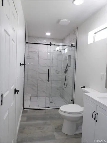 a bathroom with a toilet and shower
