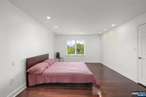 a bed room with a bed and a mirror