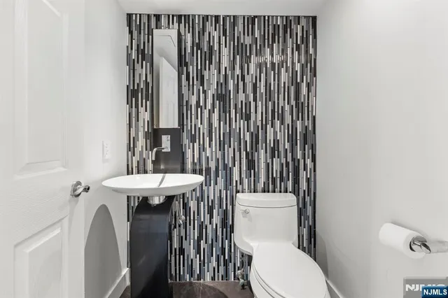 a bathroom with a sink a toilet and tub