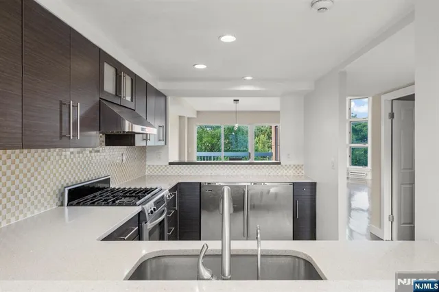 a kitchen with a sink and a stove top oven