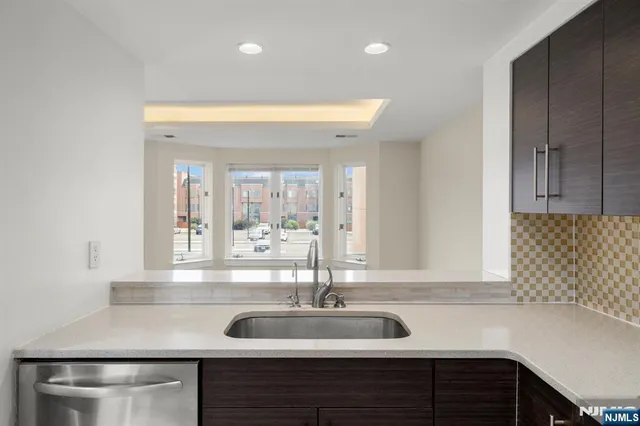 a kitchen with a sink and a wooden cabinets