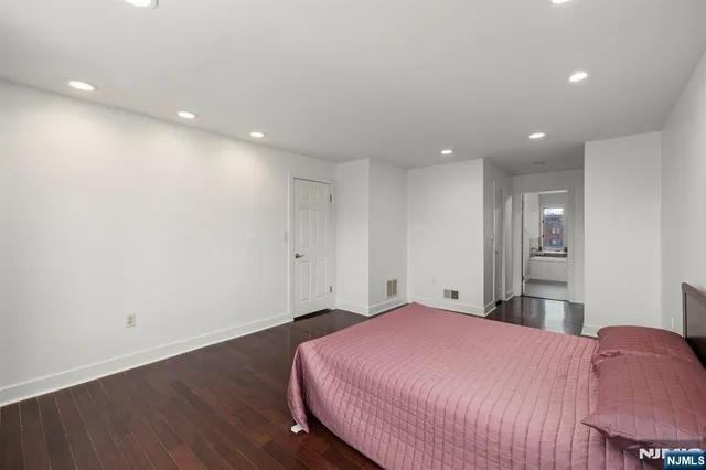 a bed room with a bed and a mirror