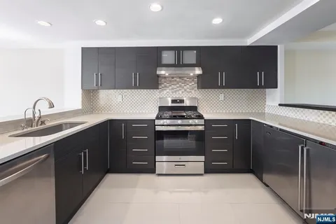 a kitchen with a sink and a stove top oven