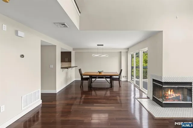 a dining room with furniture and wooden floor