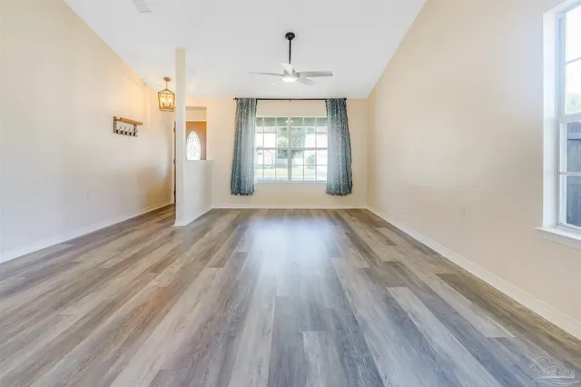 wooden floor in an empty room with a window