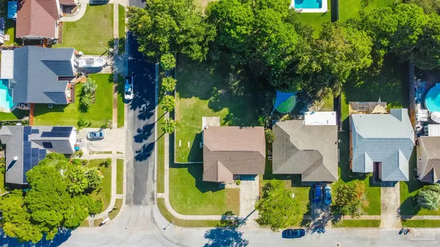 an aerial view of residential houses with outdoor space