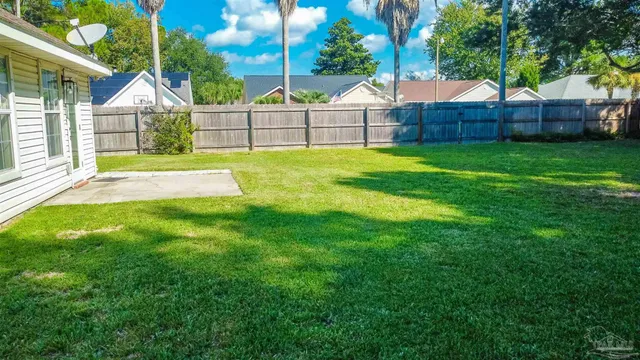 a view of a house with a yard and sitting area