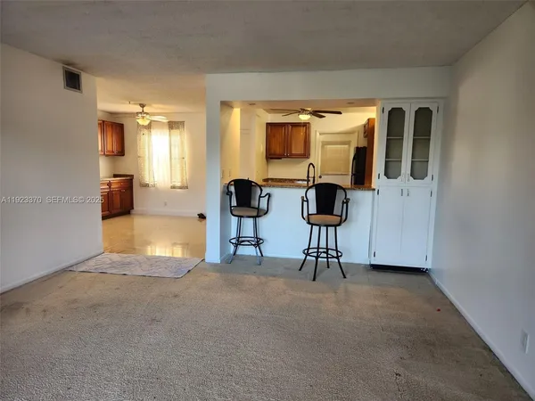 a view of living room with furniture and floor to ceiling window