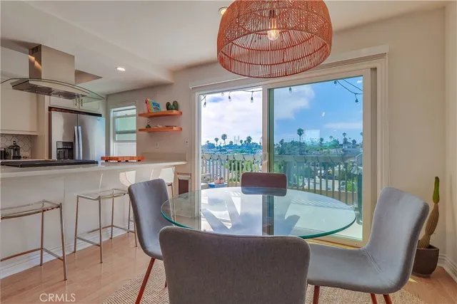 a kitchen with stainless steel appliances granite countertop a dining table and chairs