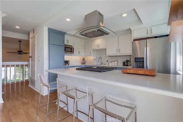 a kitchen with stainless steel appliances granite countertop a stove and a refrigerator