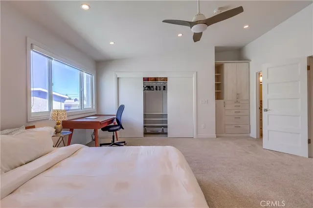 a en suite bathroom with a granite countertop sink and a mirror