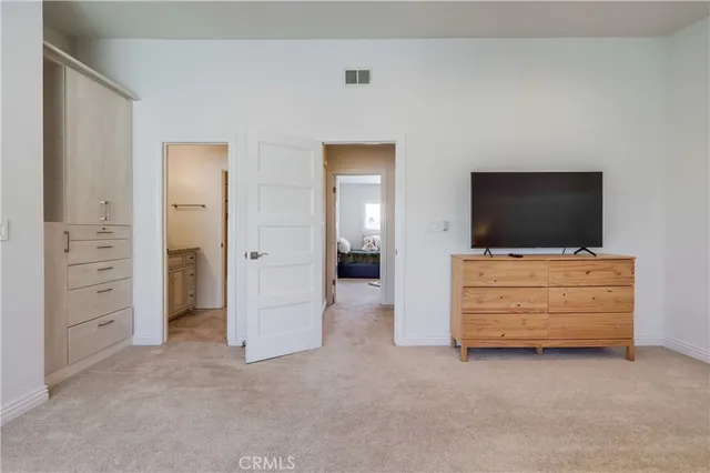 a bedroom with furniture and a rug