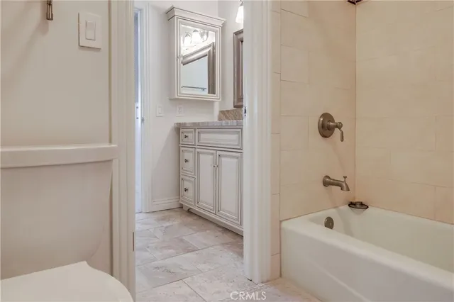 a view of a bedroom with baby crib and furniture