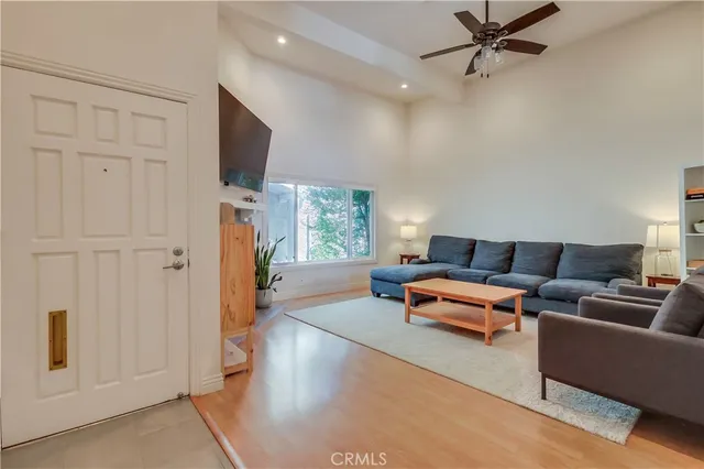 a living room with furniture flat screen tv and a fireplace