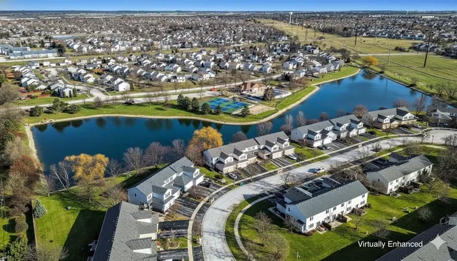 an aerial view of a house with a lake view