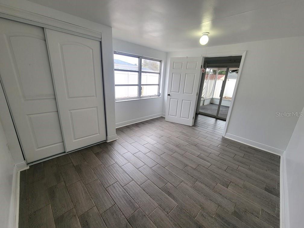 7730 Wicklow Street New Port Richey, FL 34653 - Photo 17 of 19 an empty room with wooden floor and windows