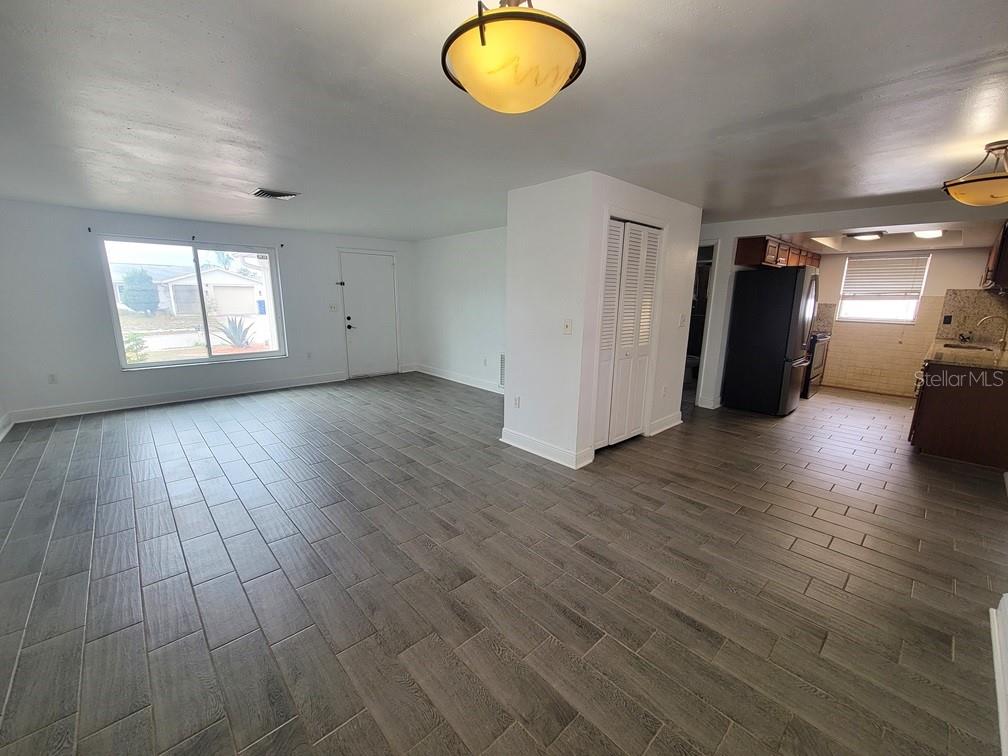 7730 Wicklow Street New Port Richey, FL 34653 - Photo 5 of 19 an empty room with wooden floor and windows