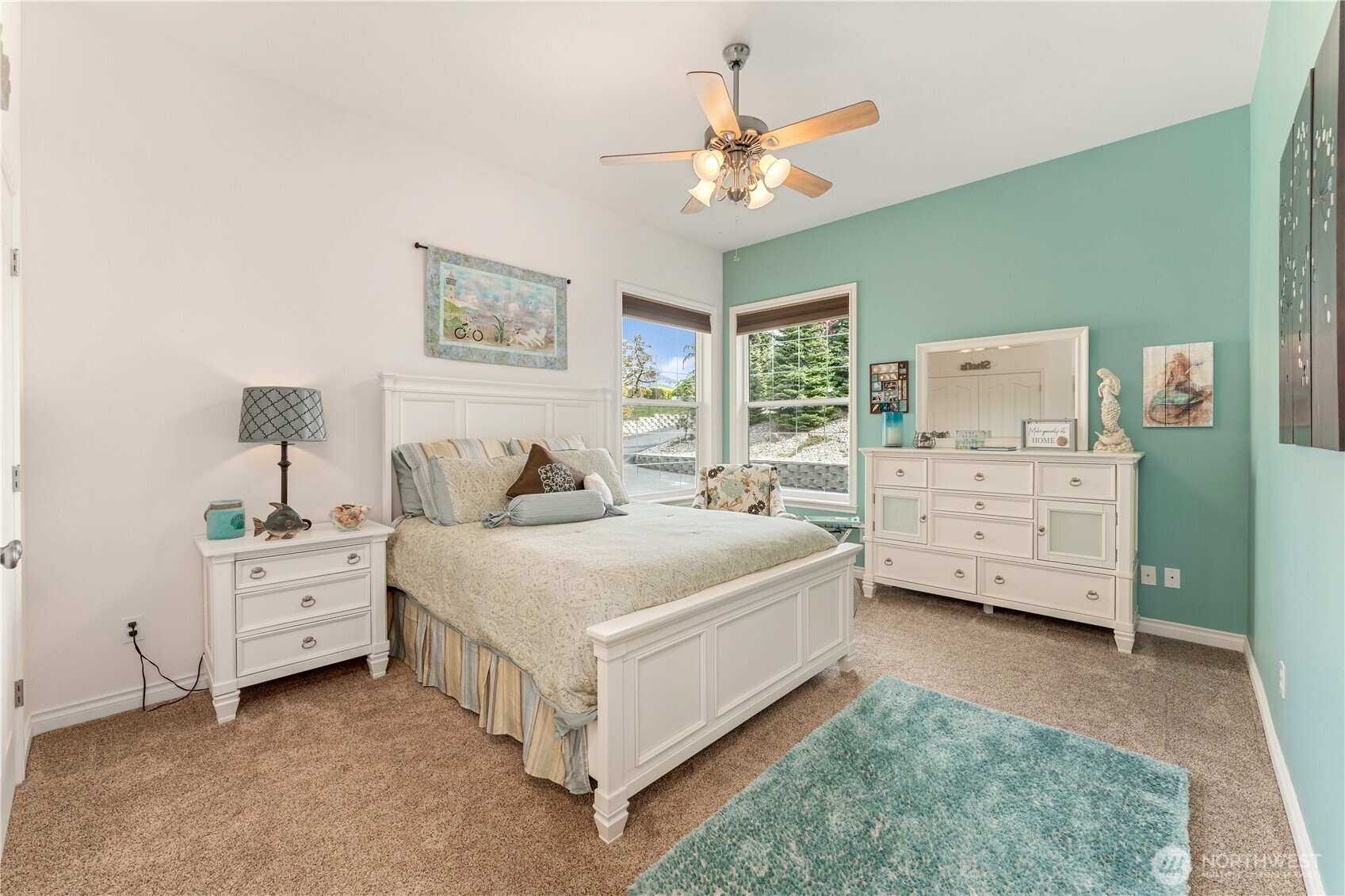 1845 Summit Boulevard Manson, WA 98831 - Photo 24 of 40 a spacious bedroom with a bed and a chandelier