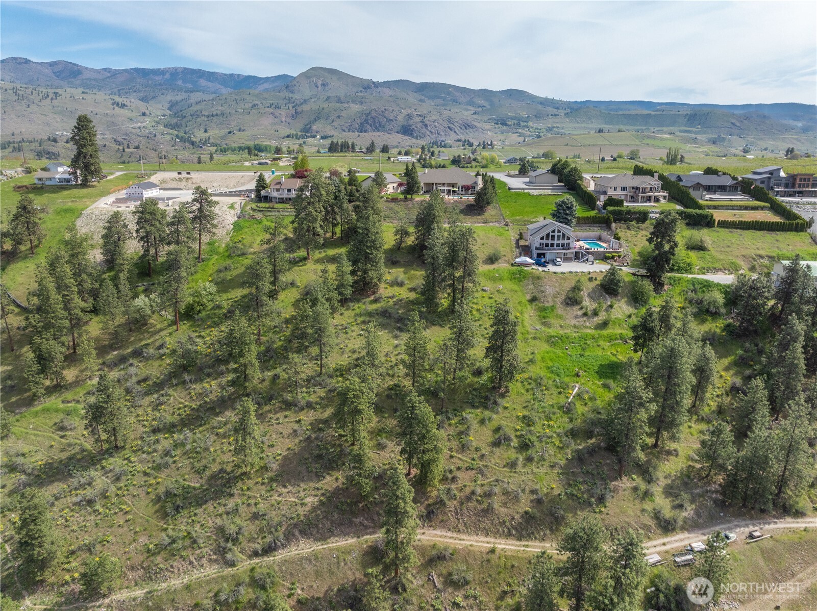 1845 Summit Boulevard Manson, WA 98831 - Photo 39 of 40 an aerial view of residential houses with outdoor space and trees