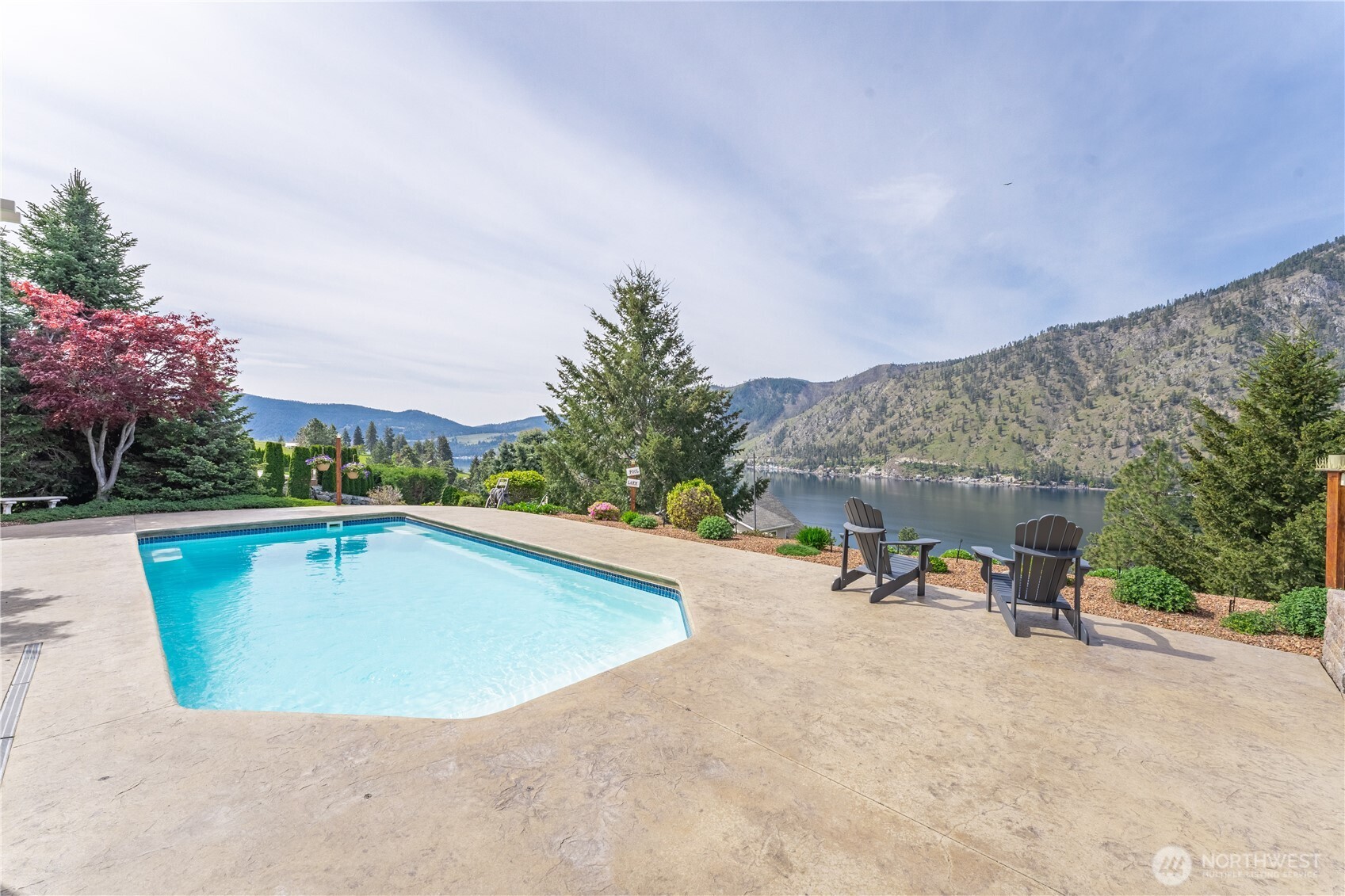 1845 Summit Boulevard Manson, WA 98831 - Photo 8 of 40 a view of swimming pool with seating space and trees in the background