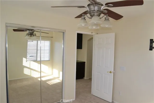 a bathroom with a chandelier fan and windows