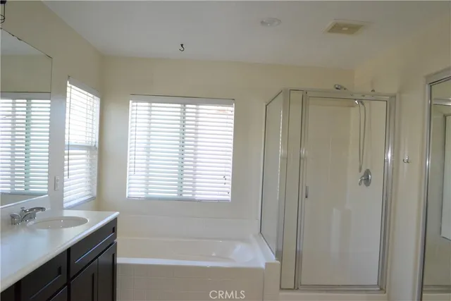 a bathroom with a shower and a glass door