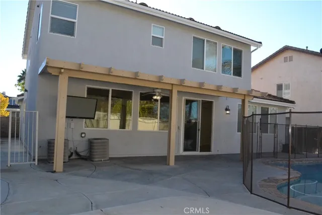 a view of a house with backyard and wooden fence