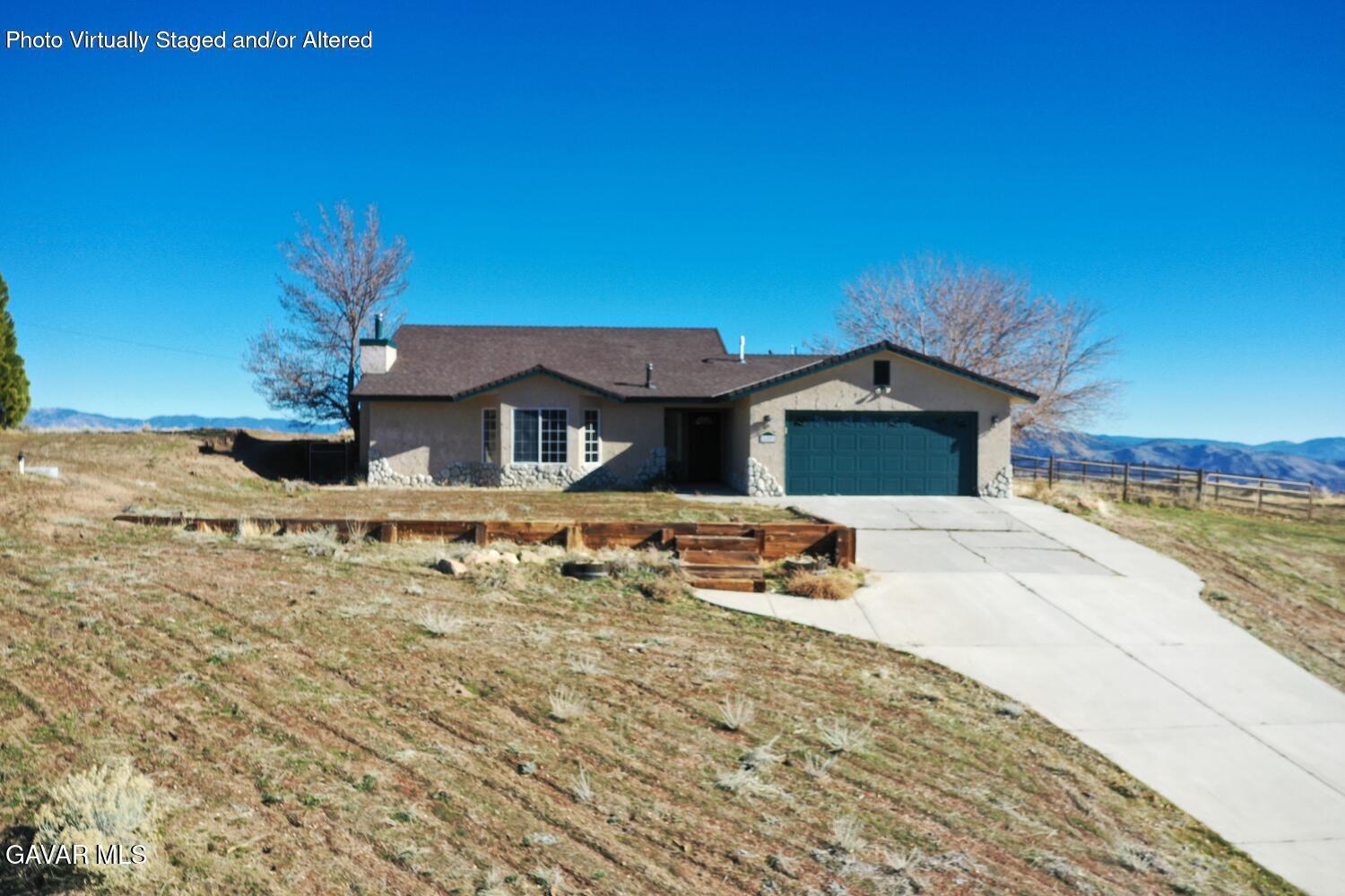26801 Cabriolet Court Tehachapi, CA 93561 - Photo 1 of 60 a front view of a house with a yard