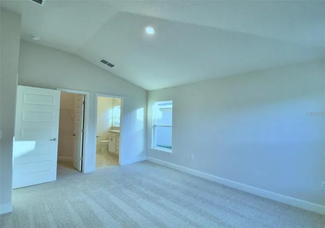 an empty room with closet and wooden cabinet