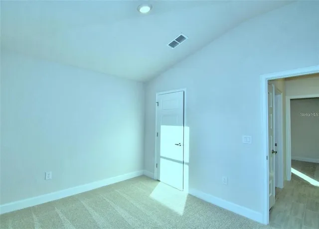 an empty room with closet area