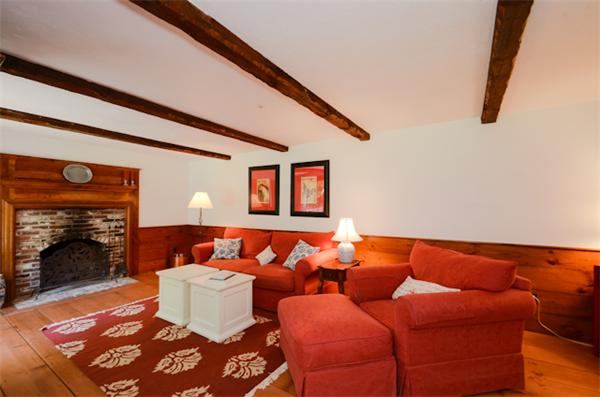 19 Oak Ridge Road Littleton, MA 01460 - Photo 10 of 30 a blue couch sitting in front of a fireplace