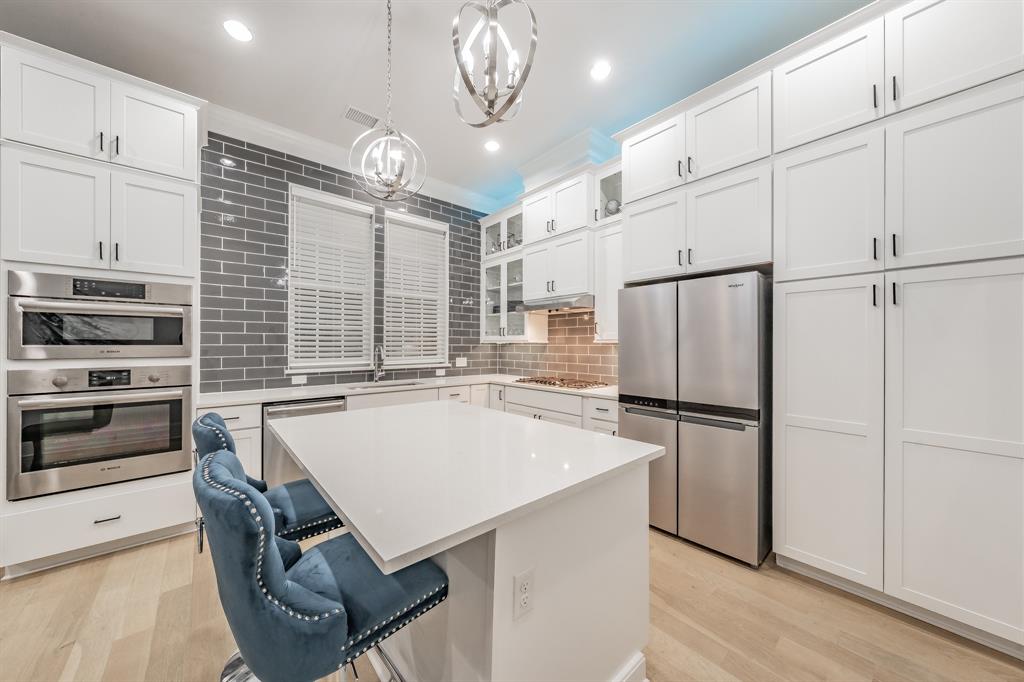 7333 Valley View Lane, Unit 902 Dallas, TX 75240 - Photo 11 of 40 a kitchen with refrigerator cabinets and a stove