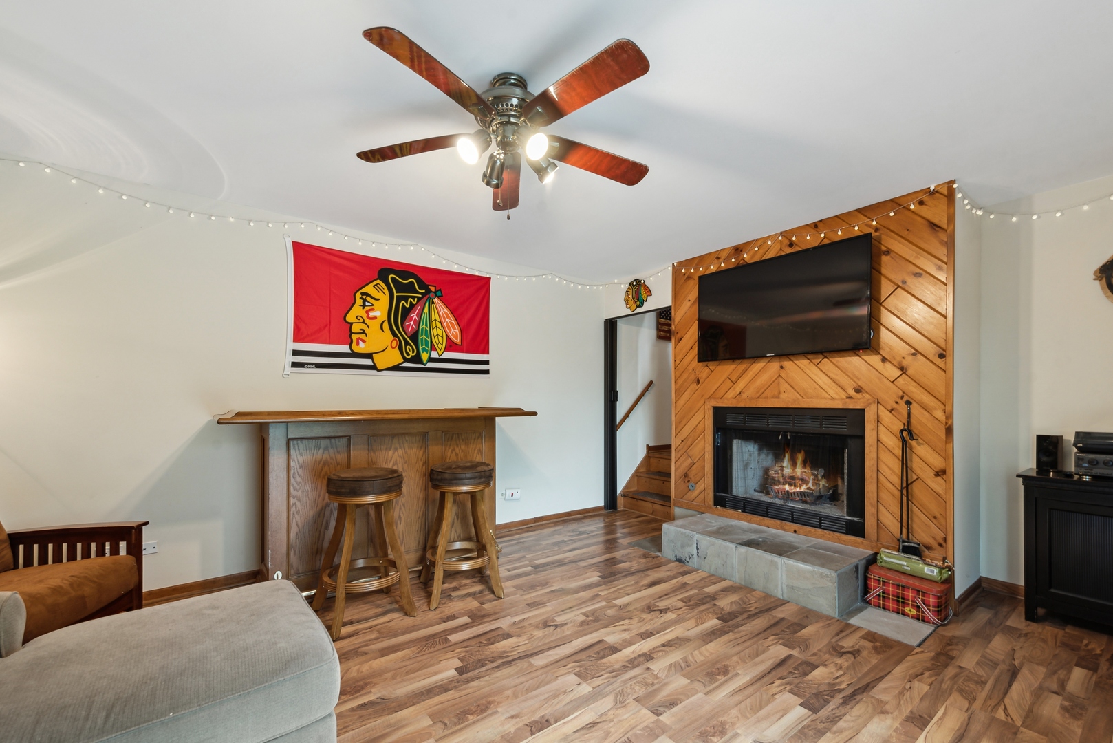 908 Pershing Drive Wauconda, IL 60084 - Photo 21 of 38 a living room with furniture a flat screen tv and a fireplace