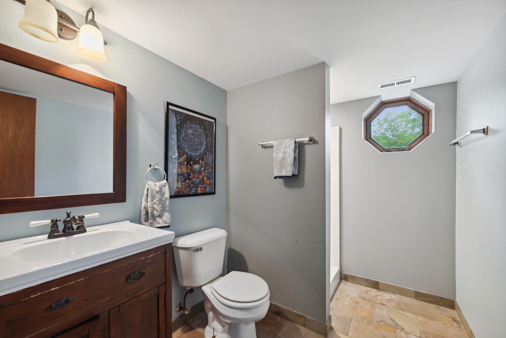 908 Pershing Drive Wauconda, IL 60084 - Photo 23 of 38 a bathroom with a toilet a sink a mirror and vanity