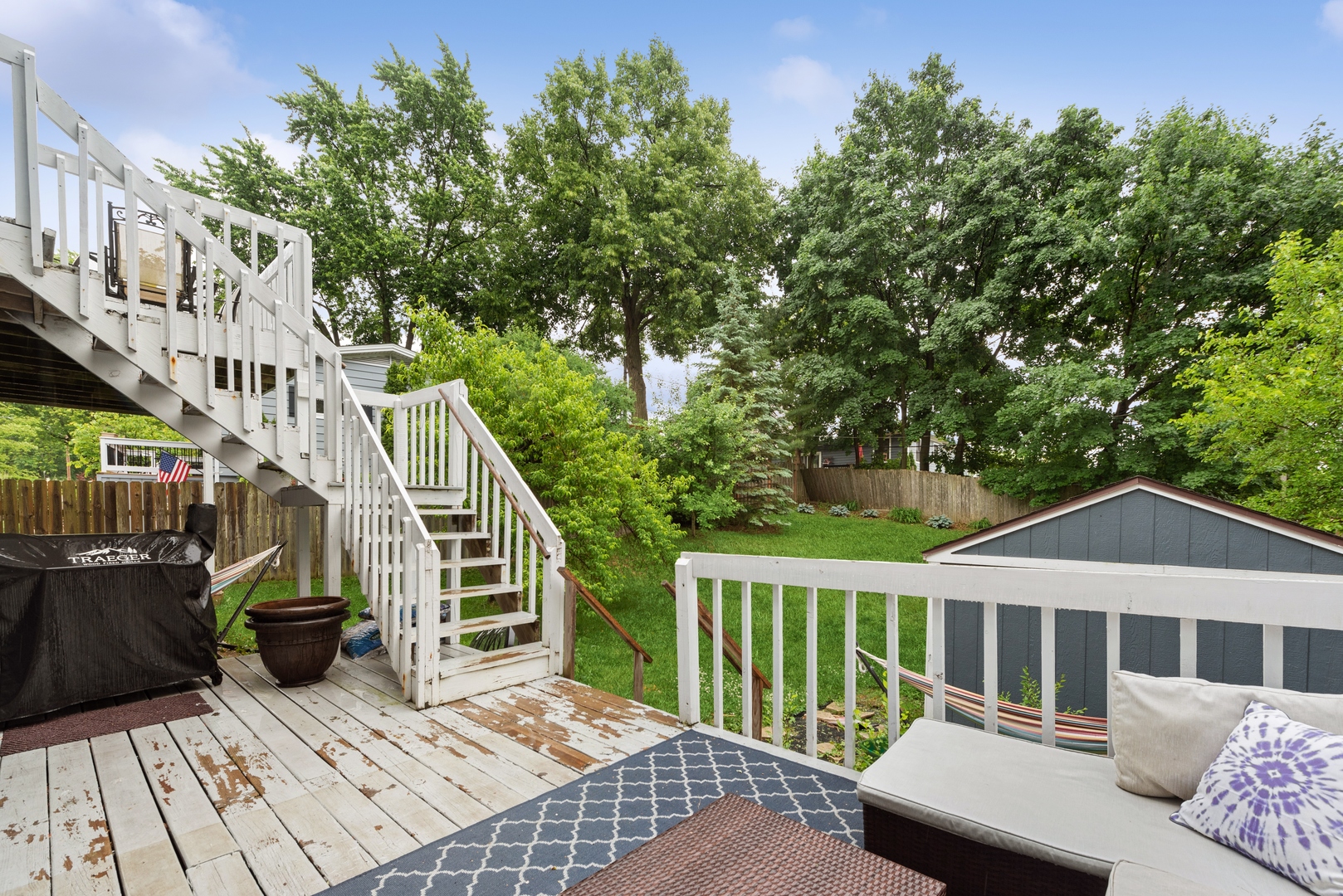 908 Pershing Drive Wauconda, IL 60084 - Photo 25 of 38 a view of a deck with couches plants and wooden fence