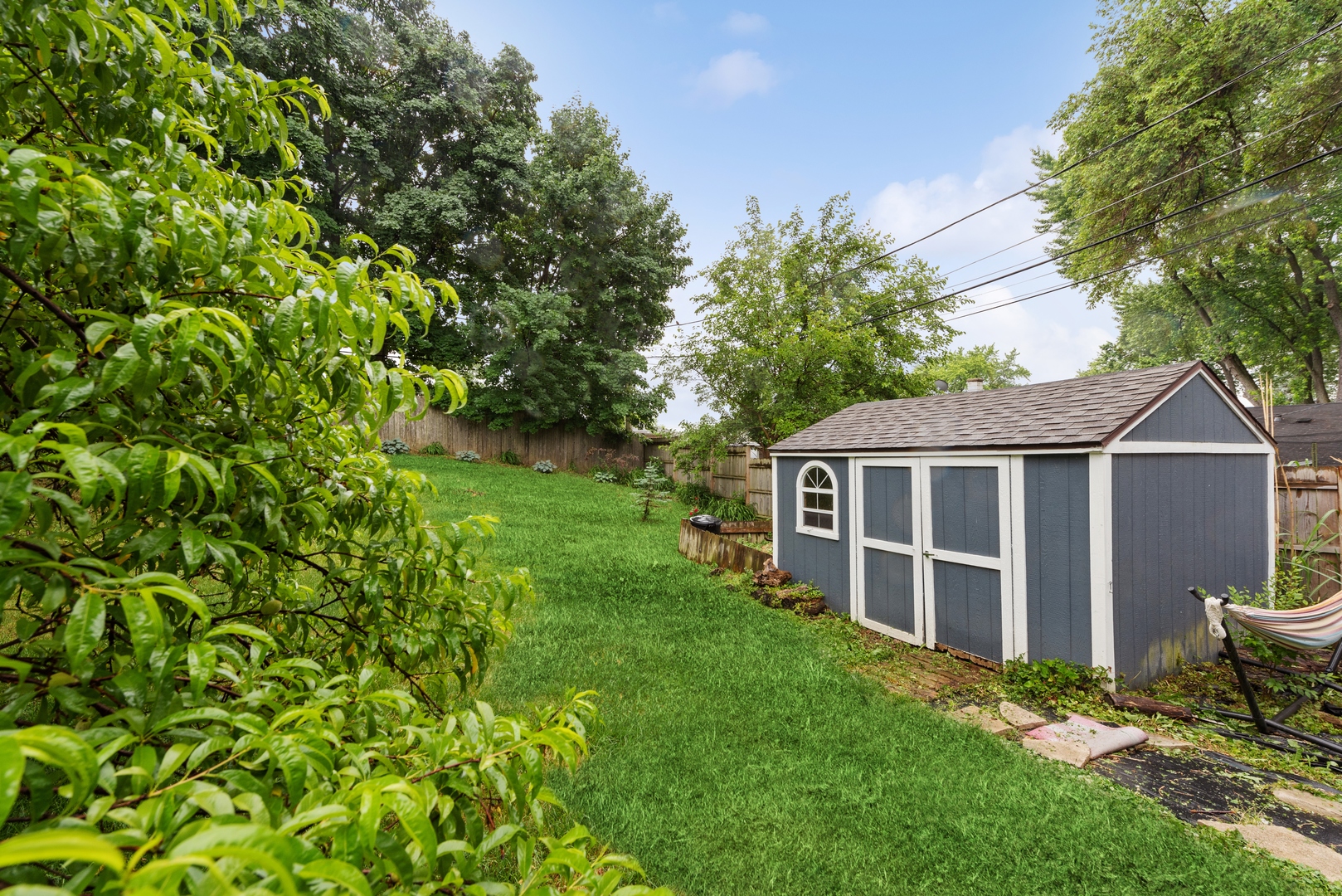 908 Pershing Drive Wauconda, IL 60084 - Photo 26 of 38 a view of a backyard with wooden fence and large trees