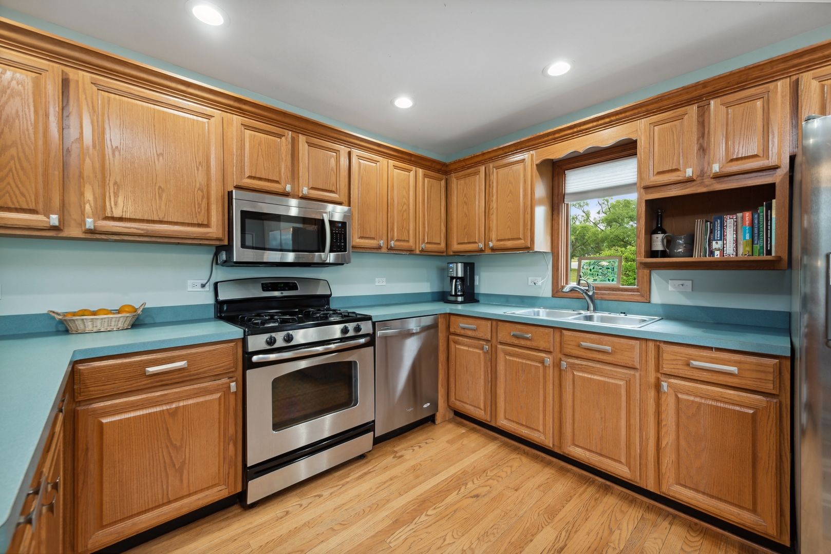 908 Pershing Drive Wauconda, IL 60084 - Photo 6 of 38 a kitchen with granite countertop wooden cabinets stainless steel appliances and a window