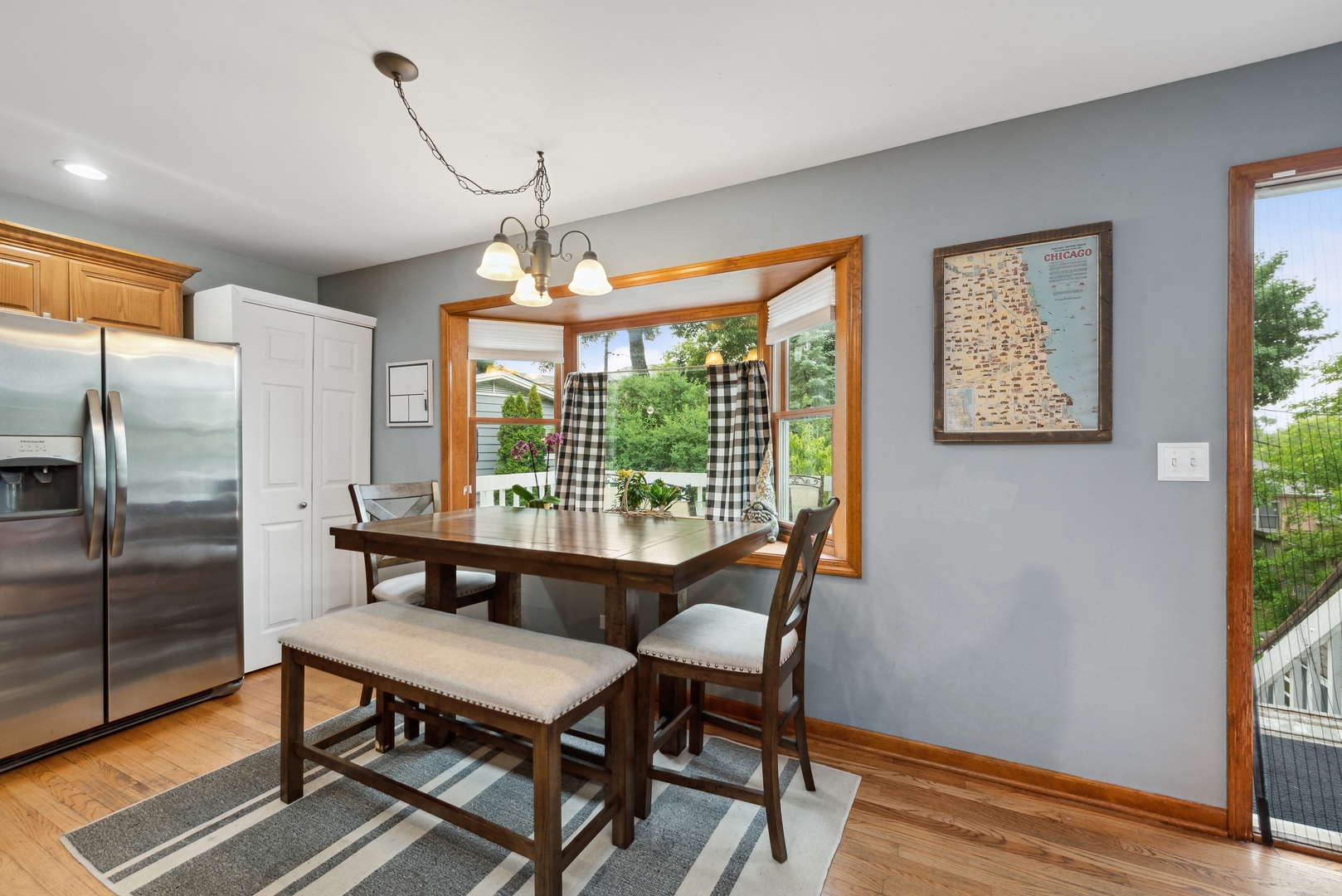 908 Pershing Drive Wauconda, IL 60084 - Photo 7 of 38 a dining room with furniture a chandelier and wooden floor