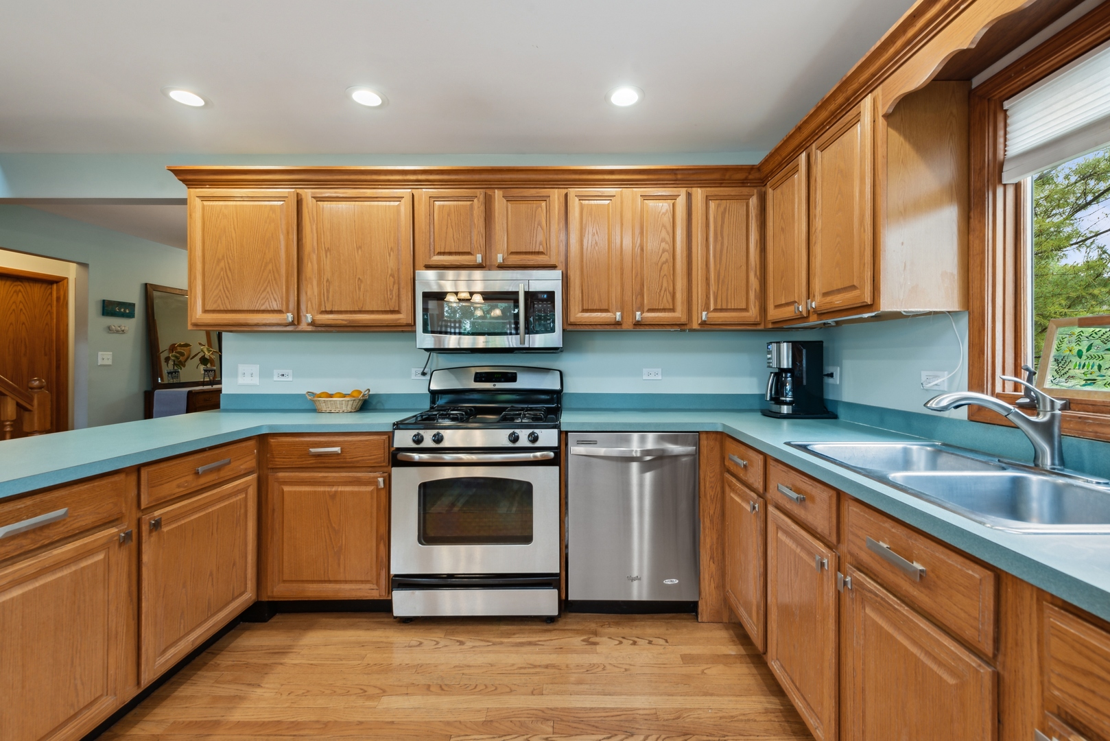 908 Pershing Drive Wauconda, IL 60084 - Photo 8 of 38 a kitchen with stainless steel appliances granite countertop a sink a stove and cabinets