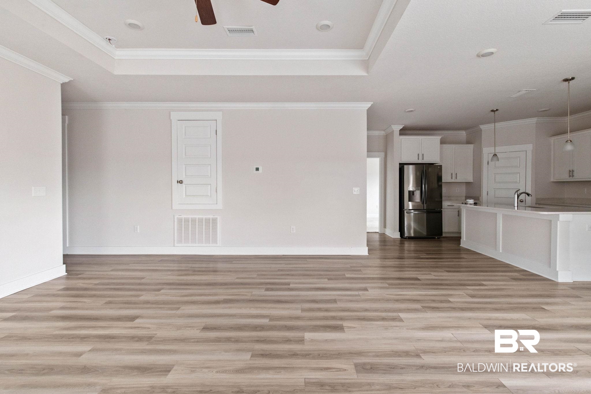 1710 Grouse Street Foley, AL 36535 - Photo 18 of 76 Spacious room featuring wood-finish flooring, tray ceiling, and a ceiling fan