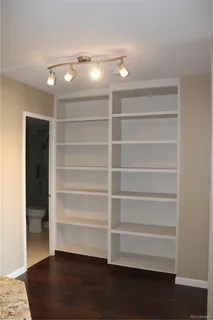 a view of walk in closet with empty racks